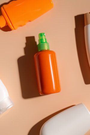 Different bottles of sunscreen cream on brown backgroundの写真素材