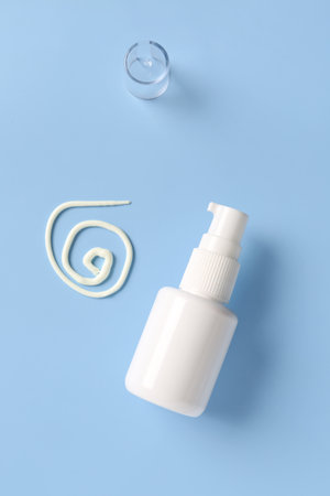 Bottle of sunscreen cream on blue backgroundの写真素材