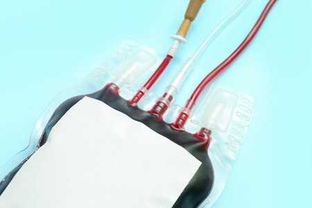Blood pack on blue background, closeup. World Donor Dayの写真素材
