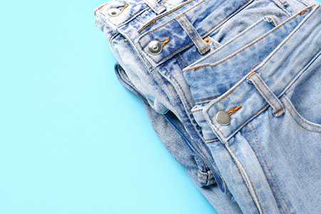 Different stylish jeans on blue backgroundの写真素材