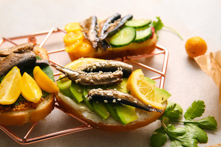 Grid of tasty sandwiches with canned smoked sprats on white backgroundの写真素材