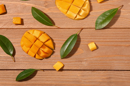 fresh cut mangoes on wooden backgroundの写真素材