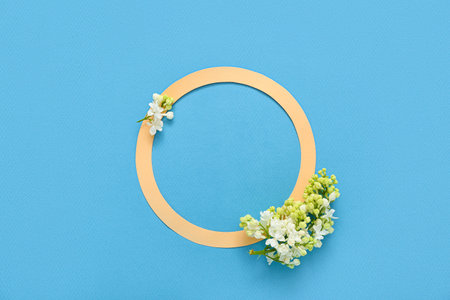 Orange blank frame and beautiful lilac flowers on blue backgroundの写真素材