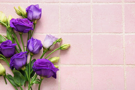 Beautiful eustoma flowers on color tile background, closeupの写真素材