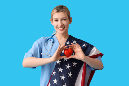 Female doctor with USA flag and heart on blue backgroundの写真素材