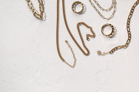 Beautiful golden jewelery on white textured background