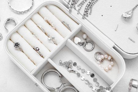 Opened organizer with stylish jewelry on white backgroundの写真素材