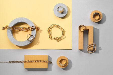 Showcase pedestals with beautiful jewelery on color backgroundの写真素材