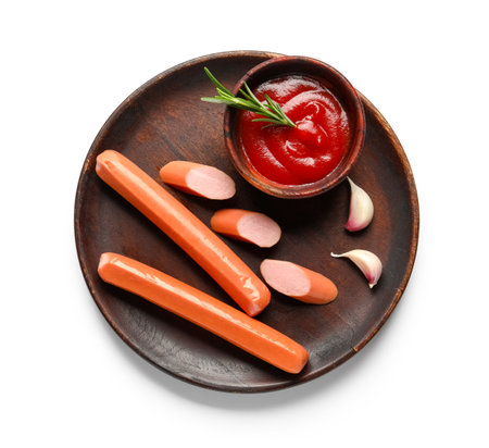 Plate with tasty sausages and ketchup on white backgroundの写真素材