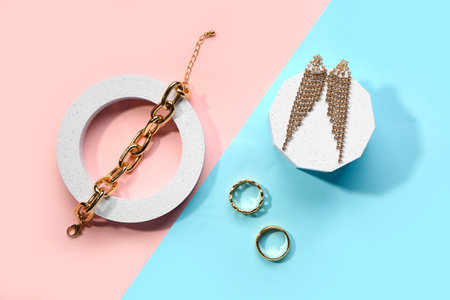 Decorative podiums with beautiful jewelery on color backgroundの写真素材