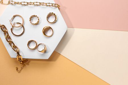Decorative podiums with beautiful jewelery on color backgroundの写真素材