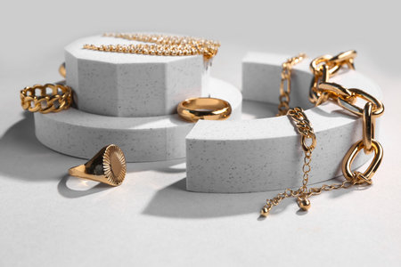 Decorative podiums with beautiful jewelery on gray backgroundの写真素材