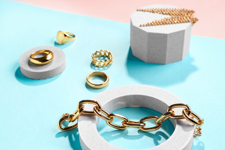 Decorative podiums with beautiful jewelery on color backgroundの写真素材