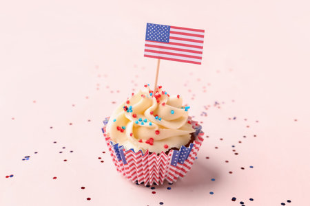 Tasty patriotic cupcake with flag of USA on pink background. american independence dayの写真素材