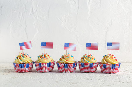 Tasty patriotic cupcakes and flags of USA on white grunge table. american independence dayの写真素材