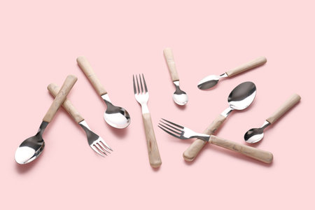 Stylish forks and spoons on pink backgroundの写真素材