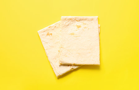 Fresh thin lavash on yellow backgroundの写真素材