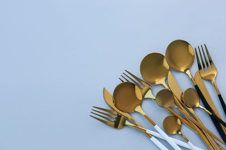 golden cutlery on blue background