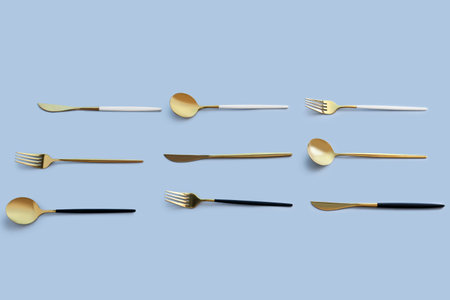 golden cutlery on blue backgroundの写真素材