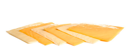 Slices of tasty processed cheese on white backgroundの写真素材