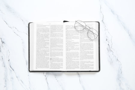 Holy Bible with eyeglasses on grunge backgroundの写真素材