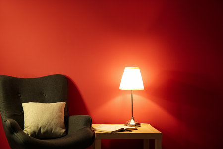Holy Bible with lamp on table in roomの写真素材