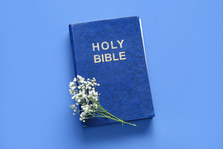 Holy Bible with flowers on blue backgroundの写真素材