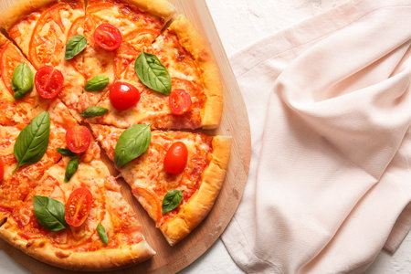 Board with tasty pizza margarita on white backgroundの写真素材