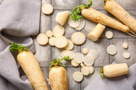 Fresh daikon radish on gray tile background