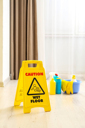 Caution sign on wet floor in room, closeupの写真素材