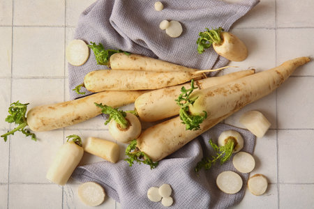 Fresh daikon radish on white tile backgroundの写真素材