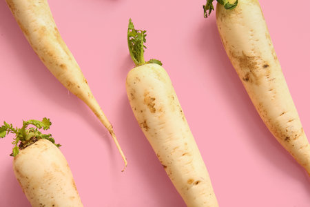 fresh daikon radish on pink backgroundの写真素材