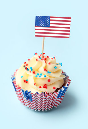 Tasty patriotic cupcake with flag of USA on blue background. american independence dayの写真素材