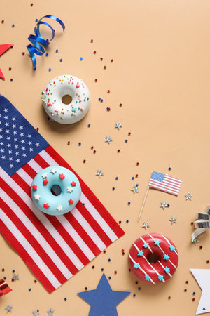 Composition with donuts, USA flags and confetti on beige background. independence day celebrationの写真素材