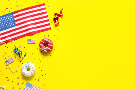 Composition with donuts, USA flags and confetti on yellow background. independence day celebration