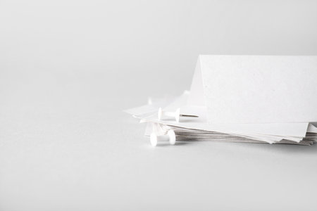 White sticky notes with pins on gray backgroundの写真素材