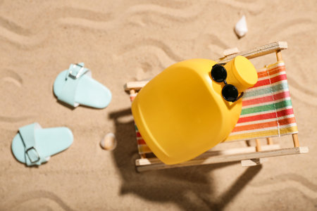 Creative composition with sunscreen cream and beach accessories on sandの写真素材