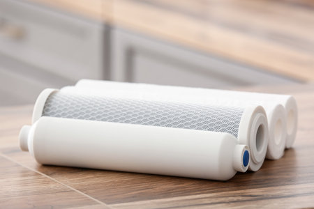 Water filters on wooden table in kitchenの写真素材