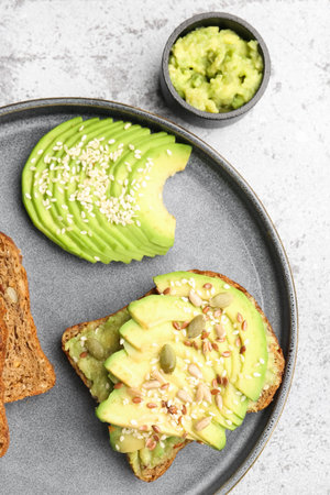 Plate of tasty avocado toast on light background, closeupの写真素材