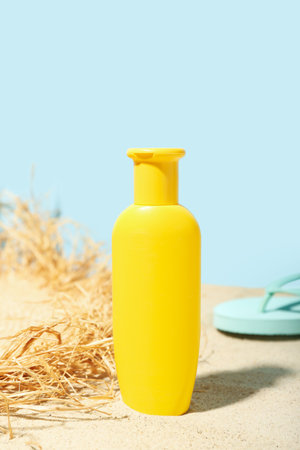 Creative composition with sunscreen cream, summer hat and flip flops on sandの写真素材