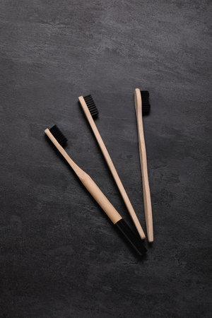 Bamboo toothbrushes on grunge black backgroundの写真素材