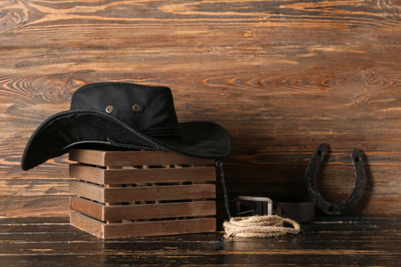 Cowboy hat, horseshoe and lasso on wooden backgroundの写真素材