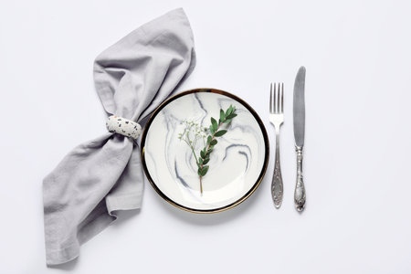 Beautiful table setting and gypsophila flowers on white backgroundの写真素材