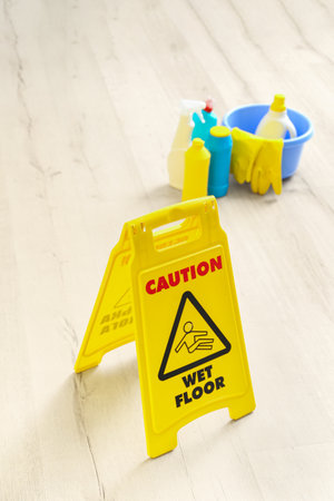 Caution sign on wet floor in room, closeupの写真素材
