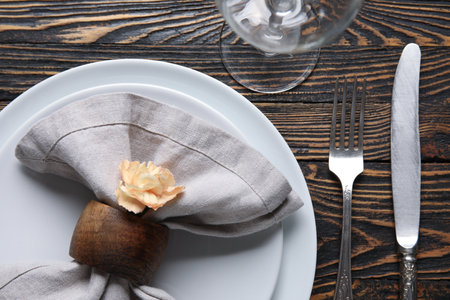 Beautiful table setting and eustoma flower on wooden background, closeupの写真素材