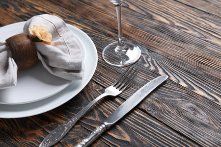 Beautiful table setting and eustoma flower on wooden background, closeupの写真素材