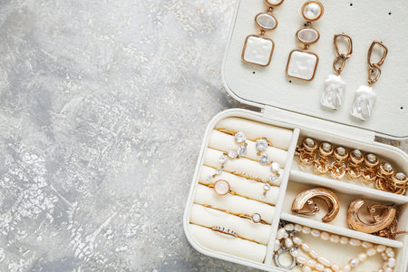 Organizer with stylish jewelry on white grunge backgroundの写真素材