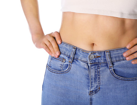 Young slim woman on white background. Diet conceptの写真素材