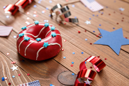 Composition with donuts, serpentine and confetti on wooden table, closeup. independence day celebrationの写真素材