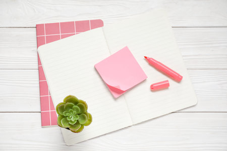 Sticky notes with notebooks on white wooden backgroundの写真素材